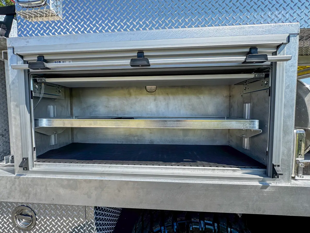 Long compartment interior close-up showing shelf and non-slip floor.